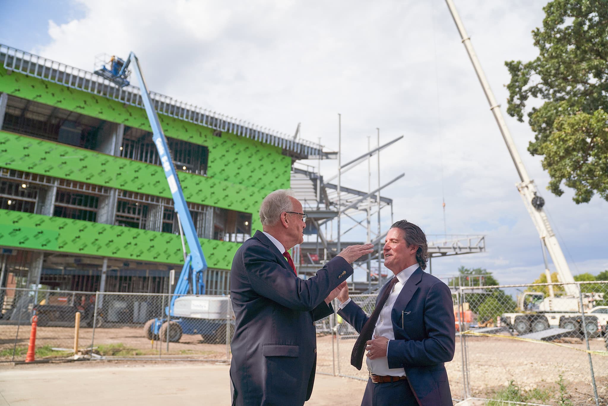 U.S. Senator Jerry Moran visits with McPherson College President Michael Schneider outside of the construction site for the new Campus Commons.